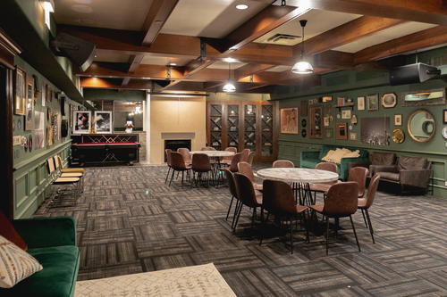 A Chicago room with tables, chairs and a pool table.