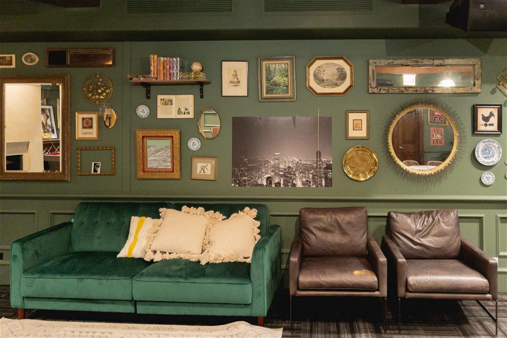 A Chicago-themed living room with a green couch and framed pictures.