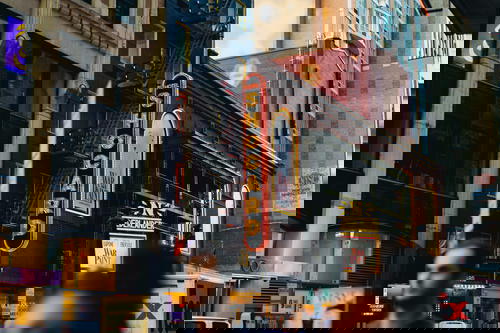 A group of people walking down a city street in Times Square, NYC.