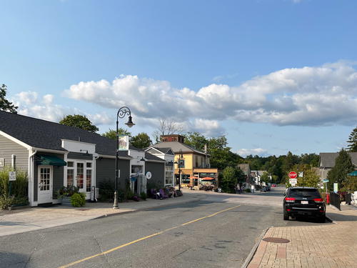 A street in Lenox, Massachusetts with parked cars.