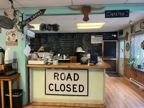 An inviting coffee shop in Litchfield, Connecticut adorned with a road closed sign inside.