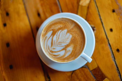 A cup of coffee on a wooden table in Pittsfield Massachusetts.