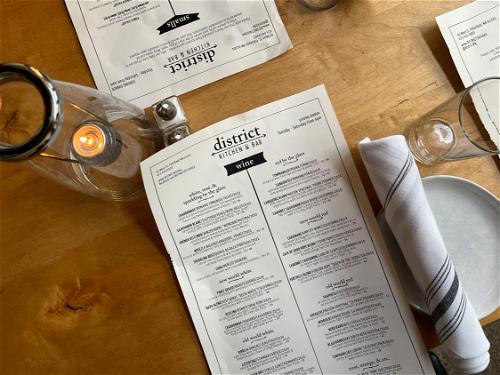 A table with a menu and glasses on it in Pittsfield.
