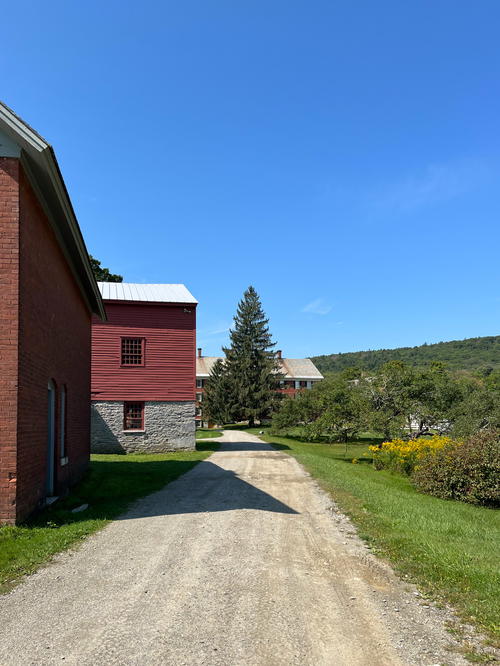 A dirt road leading to a red barn in Pittsfield.