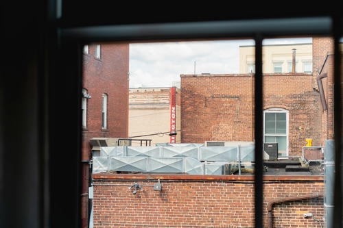 A view of a brick building in Pittsfield, Massachusetts through a window.