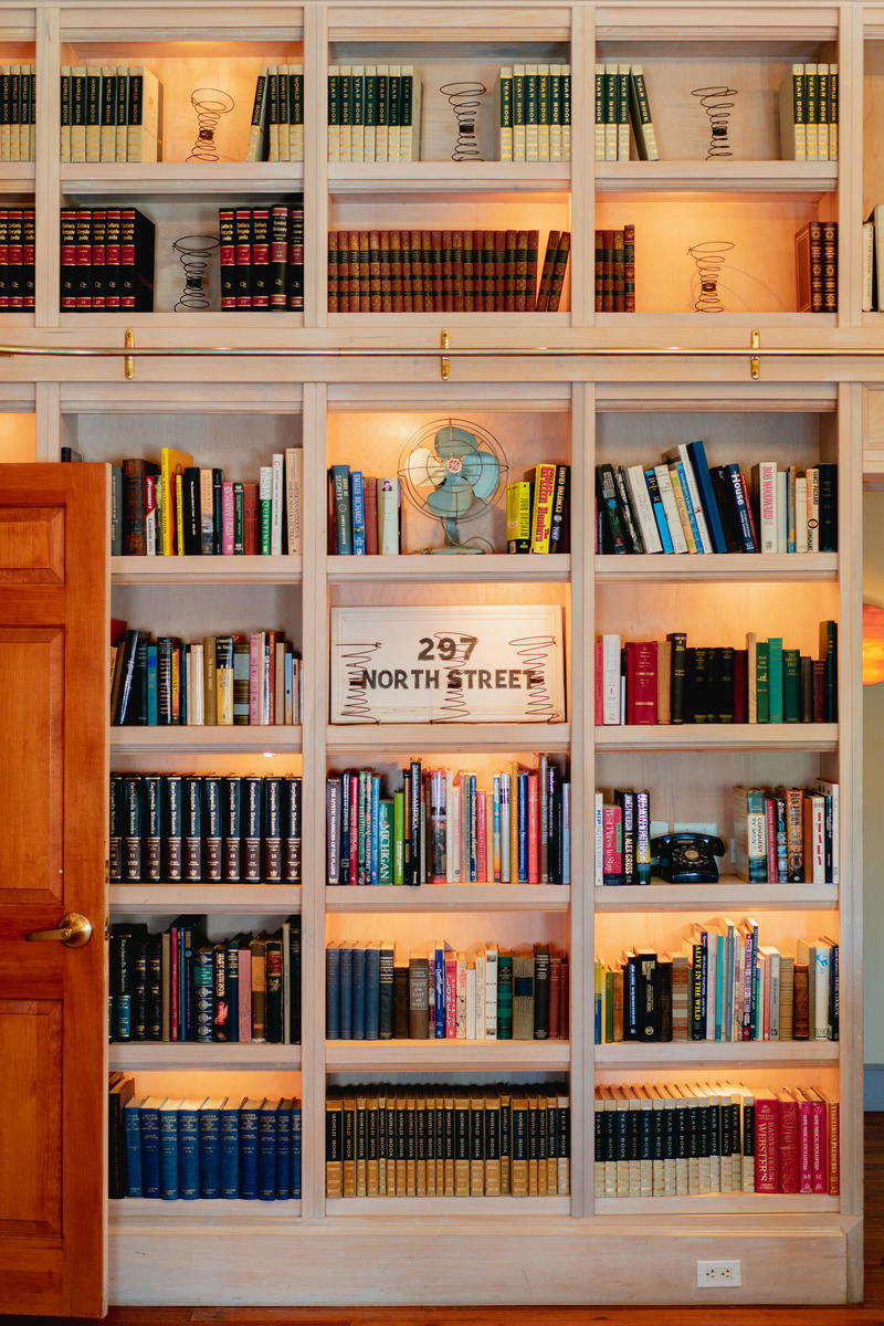 A room in Pittsfield, Massachusetts filled with many bookshelves and a door.