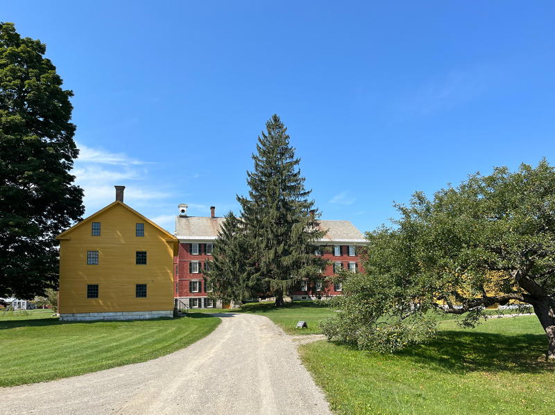 A yellow house with a tree in front of it located in Pittsfield, Massachusetts.