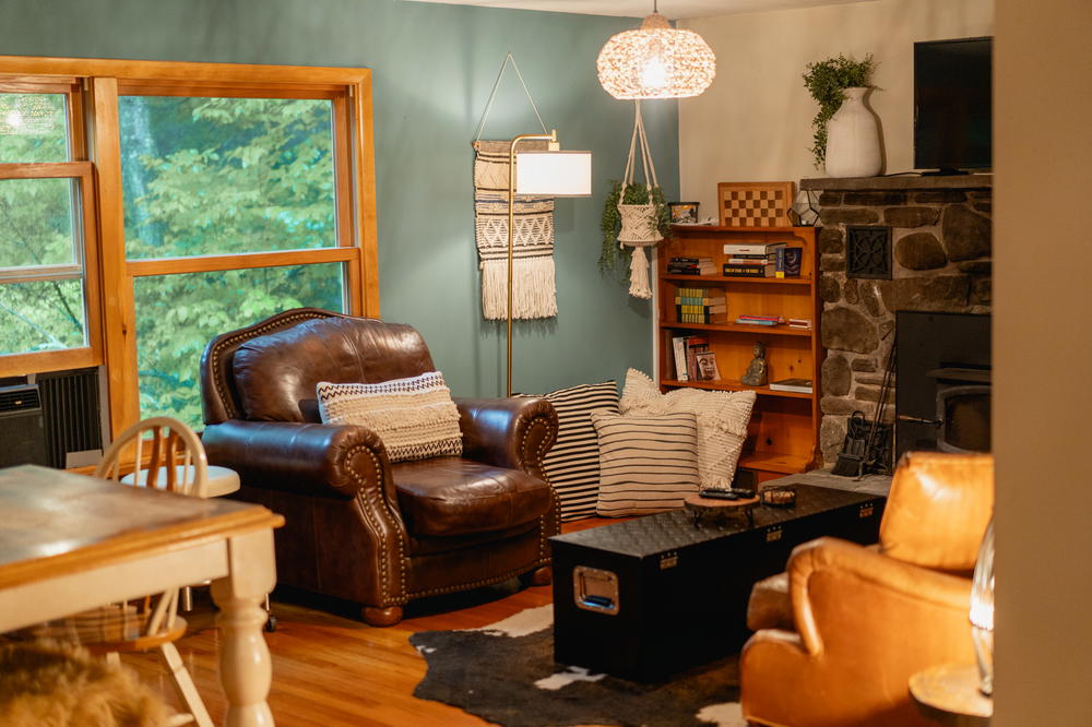 A cozy living room in The Catskills, New York featuring a fireplace.