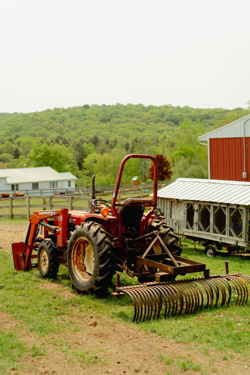A red tractor parked in the Catskills.