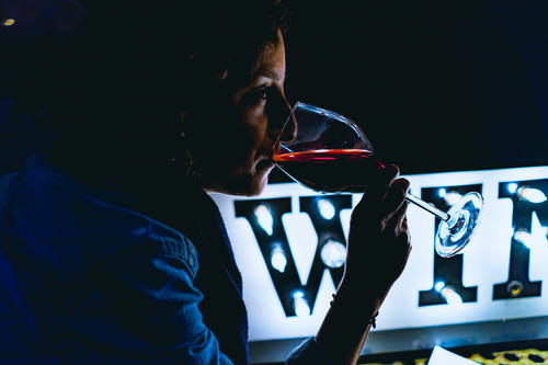 A woman in Beacon enjoying a glass of wine.