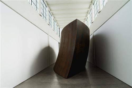 A large black sculpture in a hallway in Beacon.