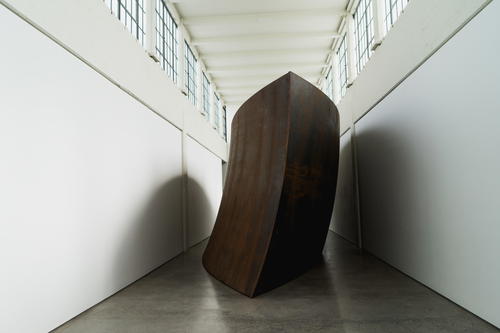 A large black sculpture in a hallway in Beacon.