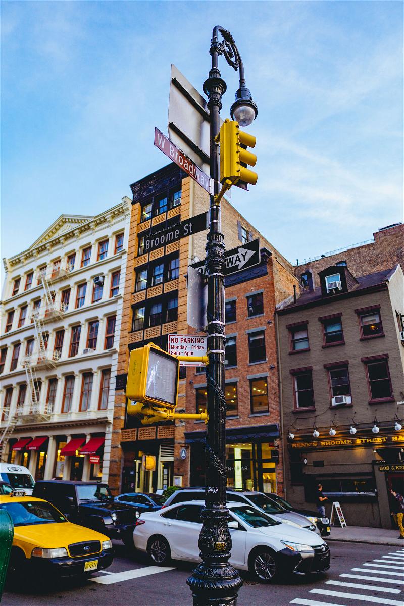 A traffic light in NYC, New York City, positioned on a pole along a bustling city street.