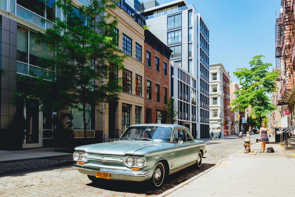 An old vintage car parked on a street in SoHo