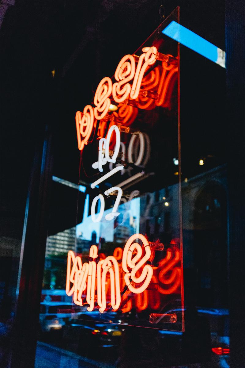 A neon sign in a window of a NYC restaurant.