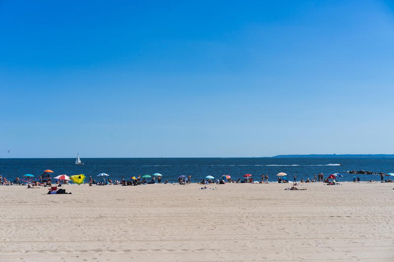 A beach with a lot of people on it.