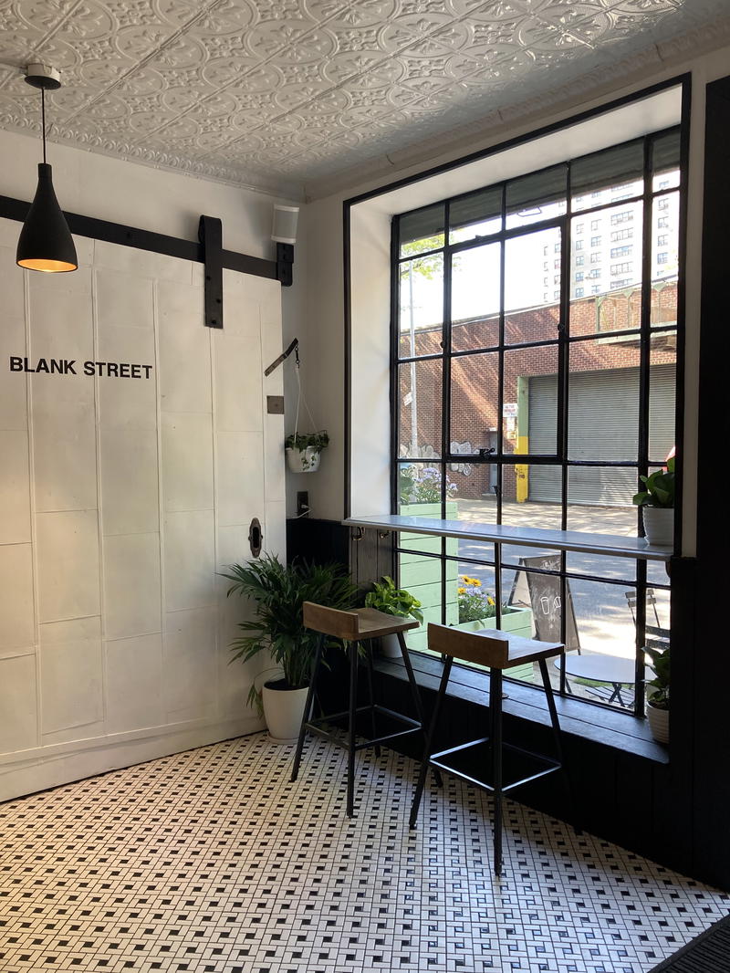 A black and white tiled floor in a restaurant located in NYC.