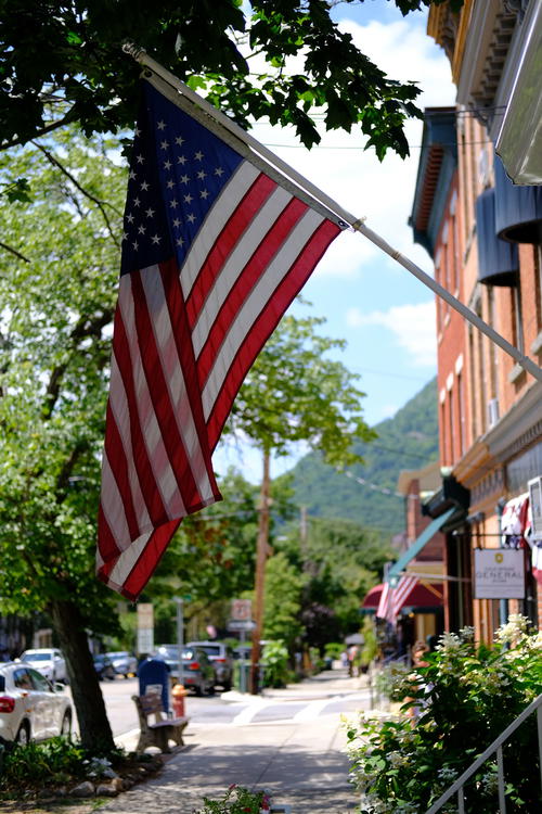 An American flag flies on a street in New York, NYC.