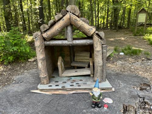 A wooden gnome house amidst the woods in New York.