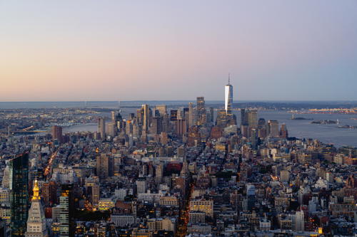 Dusk view of the Manhattan skyline featuring the Empire State Building in New York City.