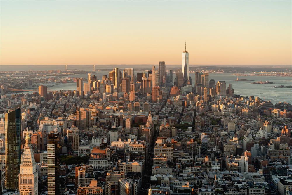 Aerial view of Manhattan skyline featuring the Empire State Building at sunset.