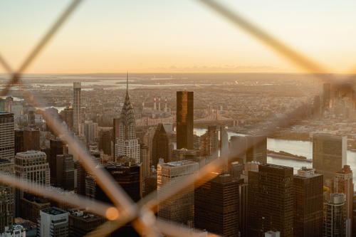 A panoramic cityscape view from the top of NYC's Empire State Building.