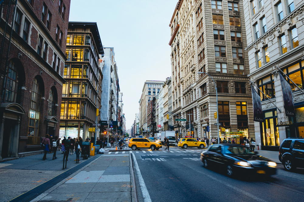 Cars driving down a busy street in New York City