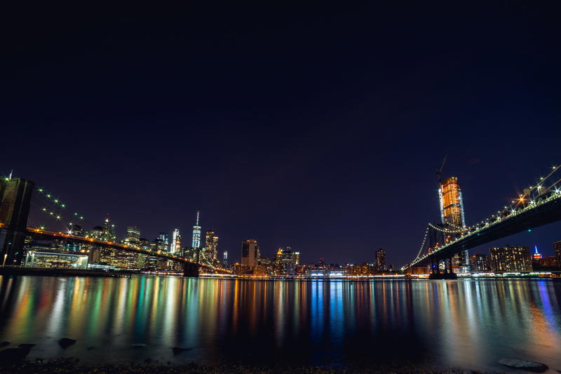 Iconic New York landmark illuminated at night, showcasing the majestic Brooklyn Bridge.