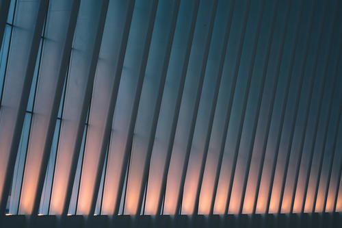 A New York City building is lit up at dusk.