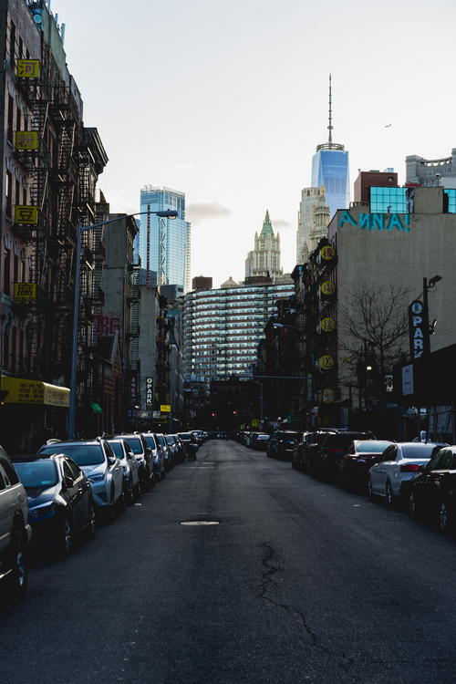 A city street with parked cars in NYC.