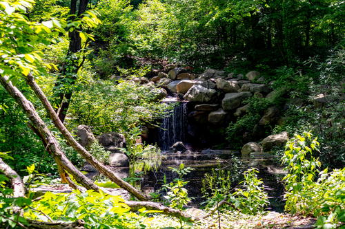 A waterfall in the middle of a wooded area in New York.