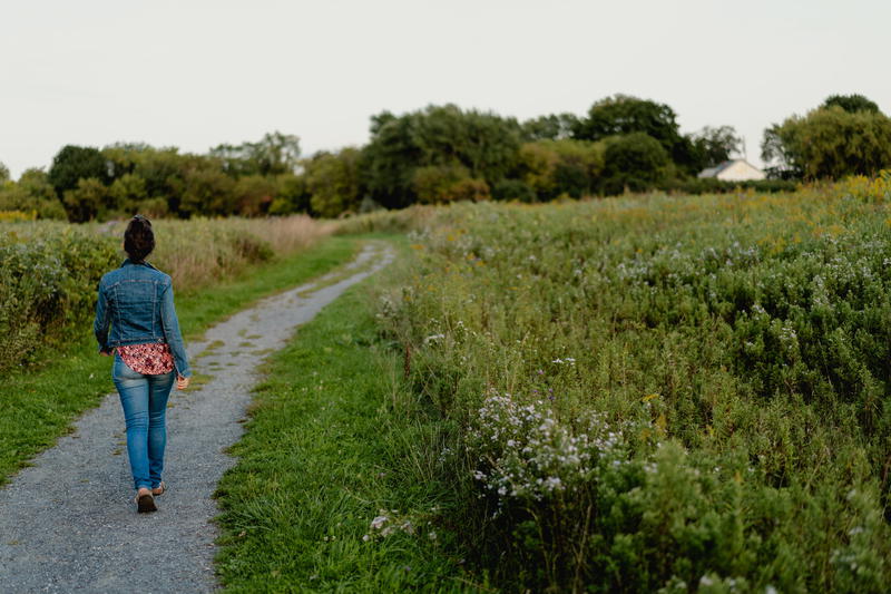 A woman strolling through the picturesque Hudson Valley countryside.