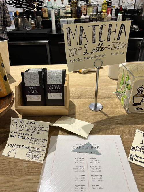 A table in NYC with a sign on it that says matcha.