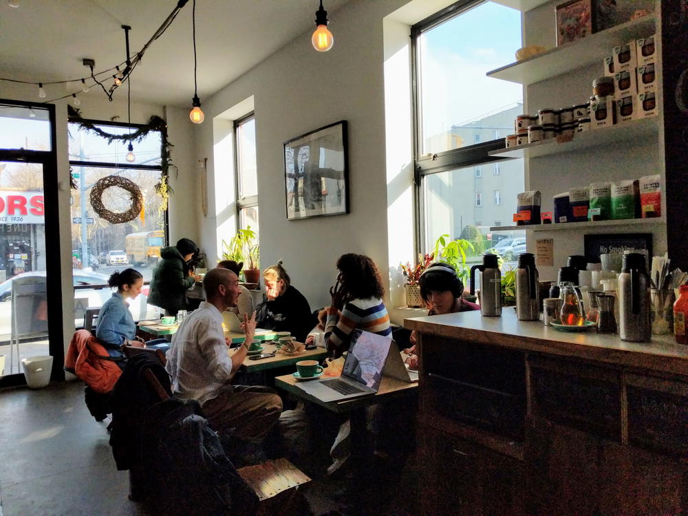 A group of people sitting at a table in a NYC restaurant.