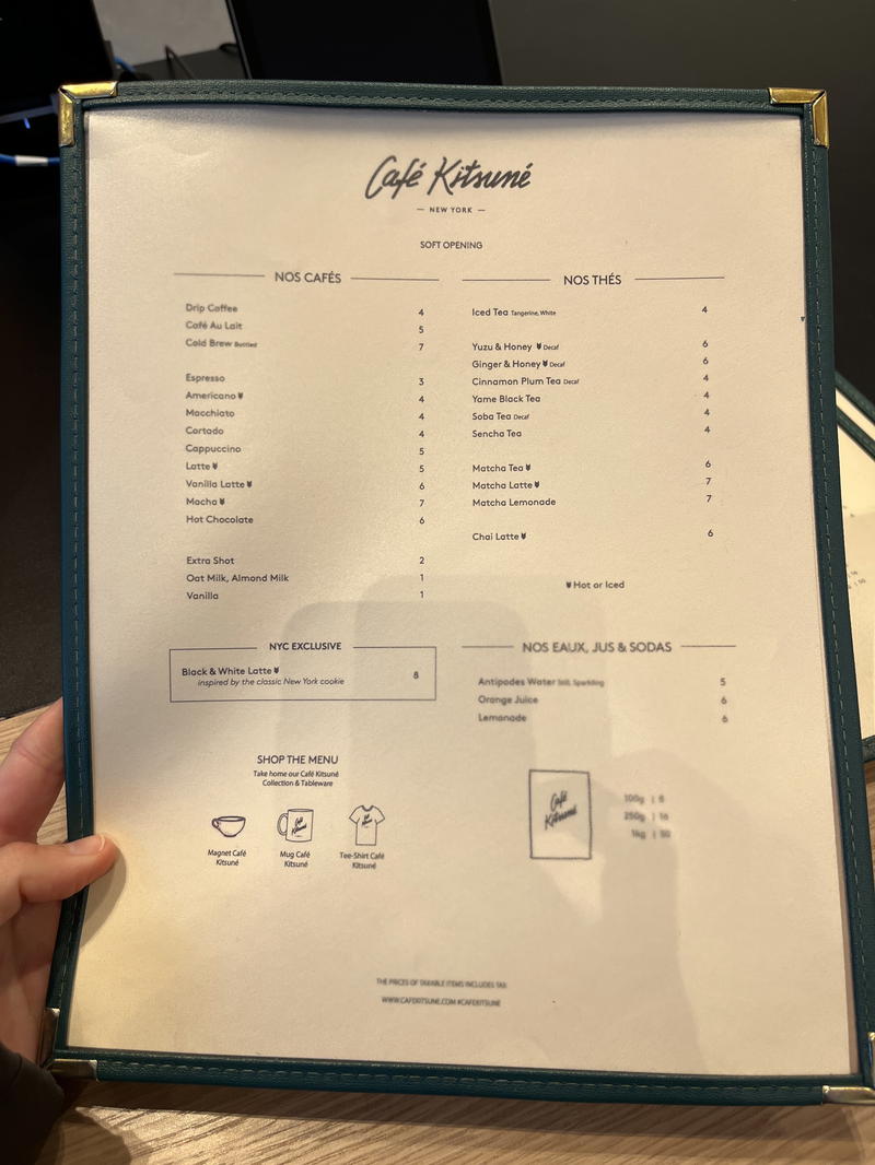 A person is holding up a menu in NYC.