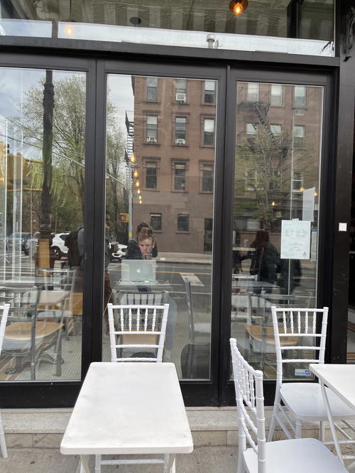 A person dining at a table in a NYC restaurant.
