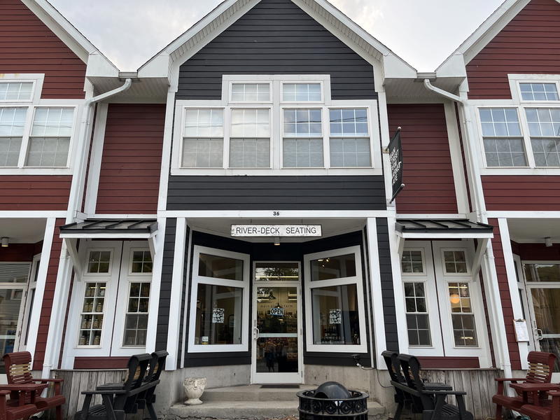 The entrance to a building in Livingston Manor with red and black siding.