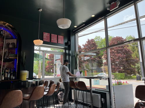 A man standing at the bar of a restaurant in Livingston Manor.