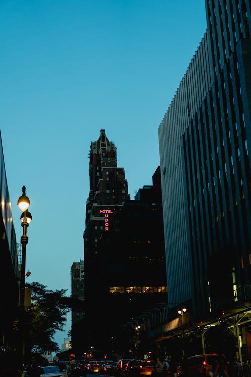 A bustling NYC street at dusk.