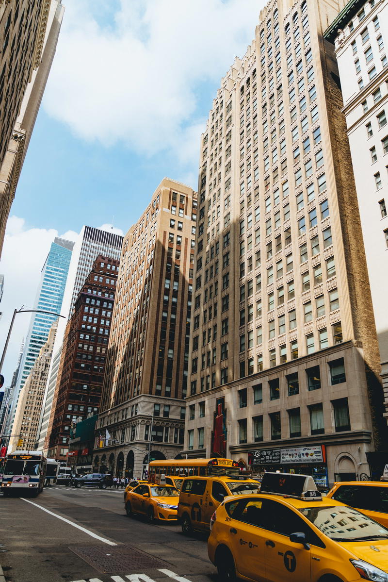 Yellow taxis on a busy street in NYC.