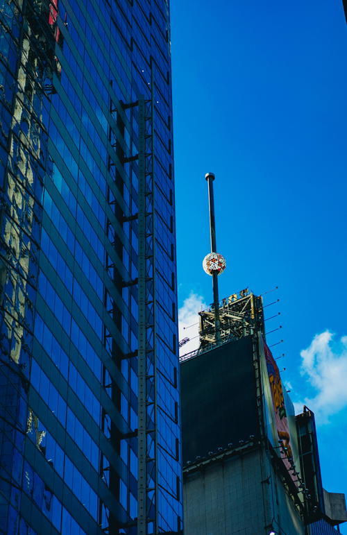 A tall building with a clock tower in Manhattan, NYC.