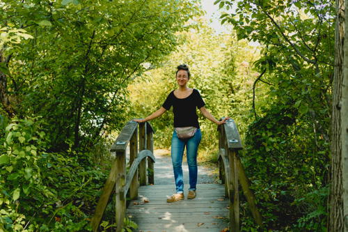 A woman standing on a wooden bridge in Saugerties, New York.