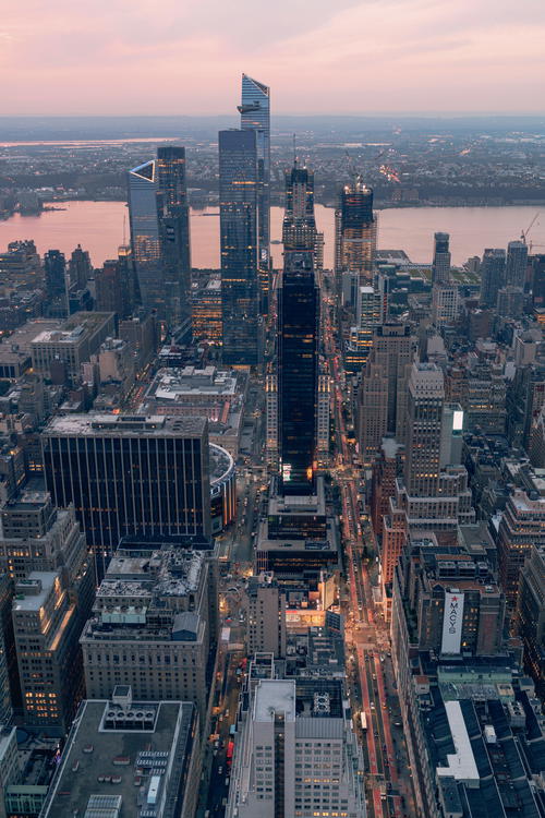 An aerial view of New York City at dusk showcasing the iconic Empire State Building.