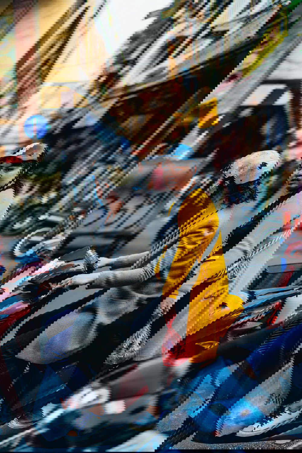 A group of people riding on a motorcycle in Hanoi, Vietnam.