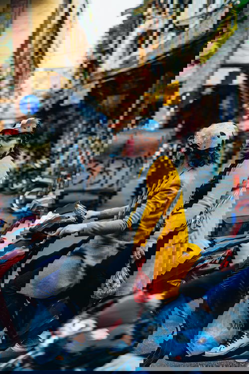 A group of people riding on a motorcycle in Hanoi, Vietnam.