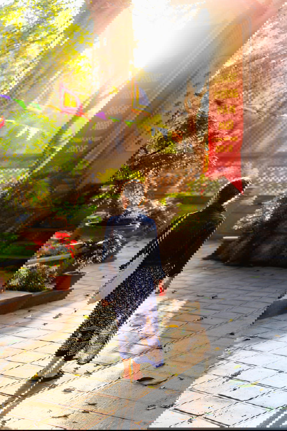 Woman walking at golden hour photography Den Quan Thanh Hanoi