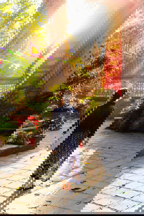 Woman walking at golden hour photography Den Quan Thanh Hanoi