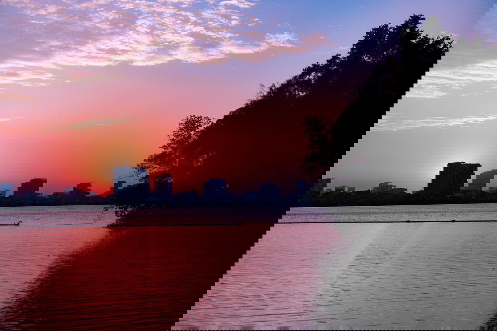The sun is setting over a lake in Hanoi.