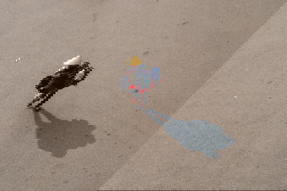 An aerial view of a woman walking down a street in Hanoi, Vietnam.