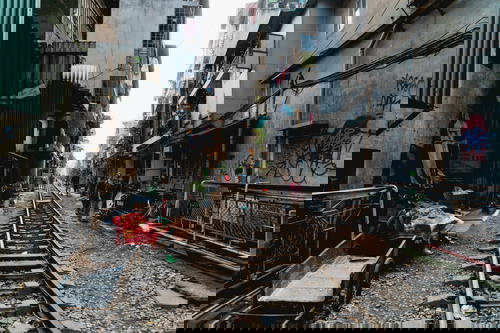 A narrow alleyway in Hanoi, Vietnam with a train track.